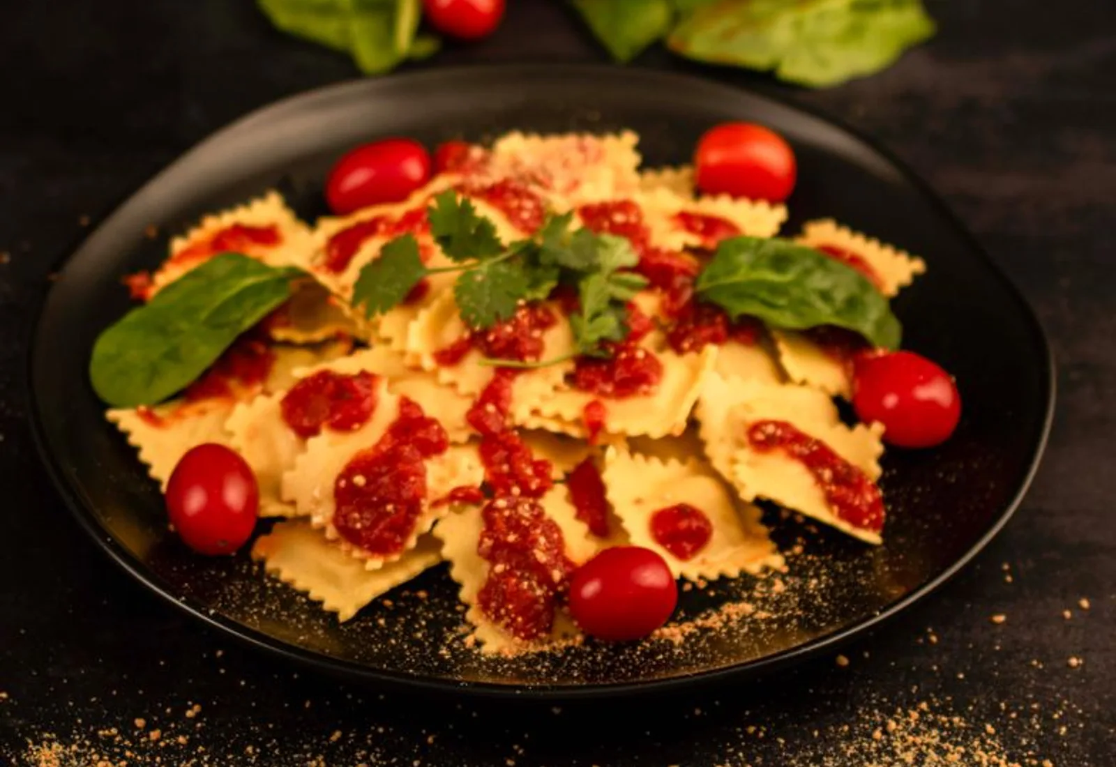 Hand-folded ravioli plated dark with a light cream sauce