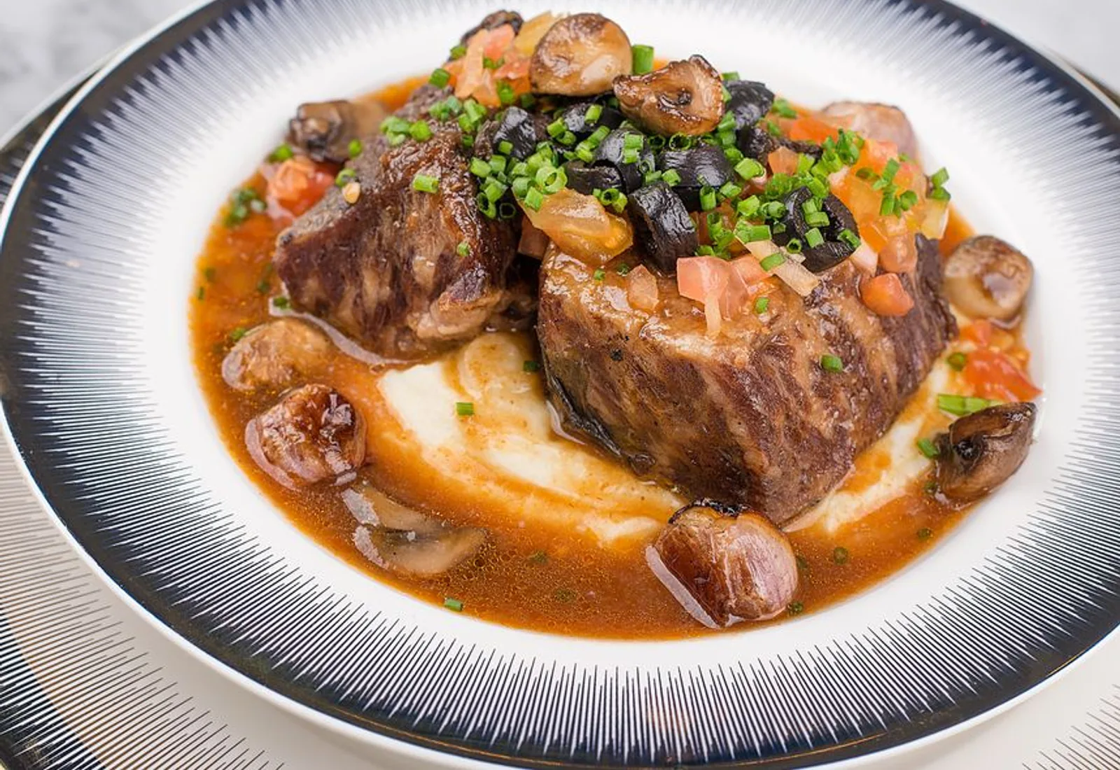Braised veal shank over saffron risotto with a rosemary sprig
